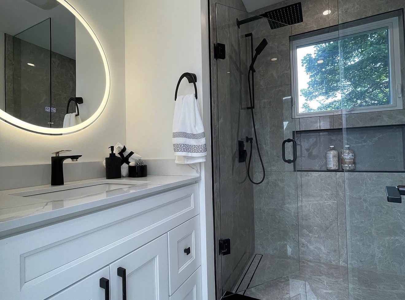 Renovated ensuite bathroom with marble tile and matte black fixtures